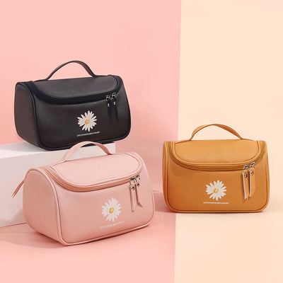Cosmetic storage bag - multifunctional PU makeup bags in black, pink, and mustard yellow with daisy design and top handle for travel use.