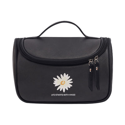 Black toiletry bag with a white daisy logo and 'Life Starts with Hikoo' text on a white background