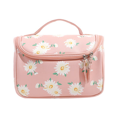 Pink toiletry bag with floral pattern on a white background