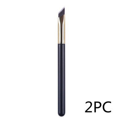 Eyebrow brush with black handle and gold accents on a white background, labeled '2PC'.