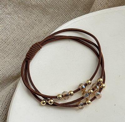 Brown Durable Hair Rope Adult Hair Elastic Band featuring gold and amber-toned beads, ideal for secure and stylish ponytails.