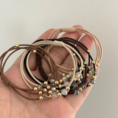 Durable Hair Rope Adult Hair Elastic Band set in assorted colors with gold and crystal beads, shown in hand for size reference.