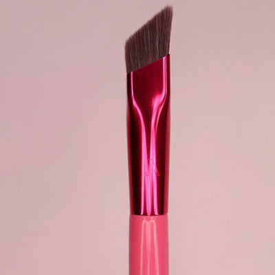 Pink makeup brush with a reflective handle on a pink background.