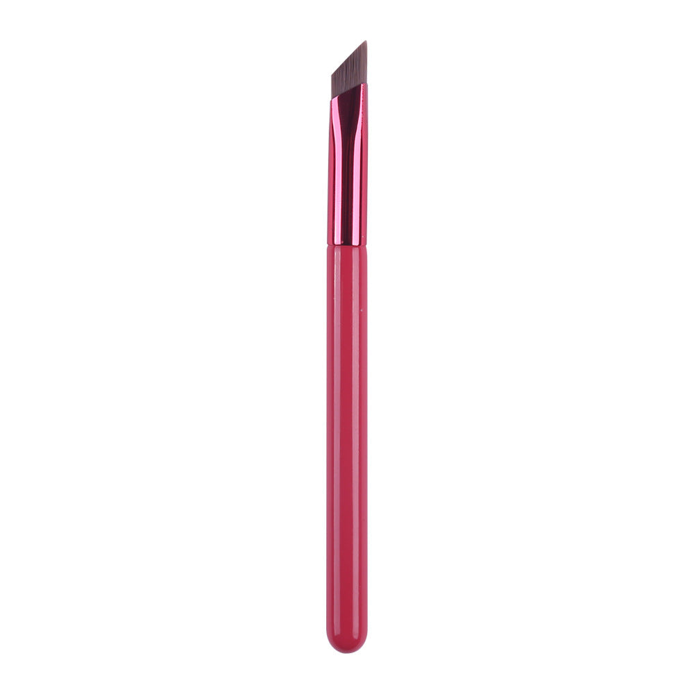Red makeup brush with a pointed tip on a white background